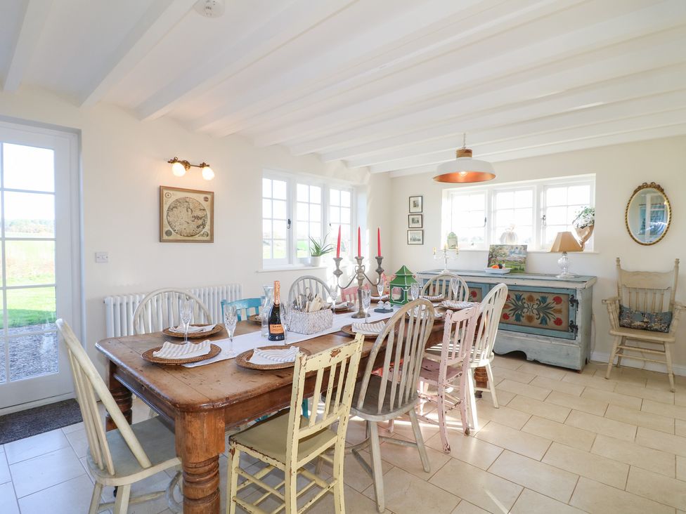 A dining room with a wooden table and chairs at Gapstile in Abbots Bromley