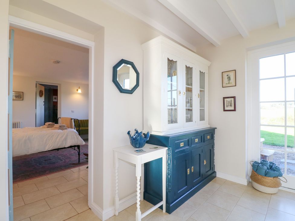 An entryway with a cabinet and mirror at Gapstile in Abbots Bromley