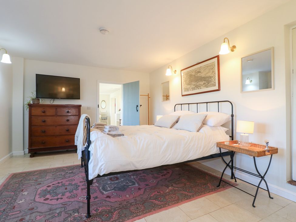 A bedroom with a bed and dresser at Gapstile in Abbots Bromley