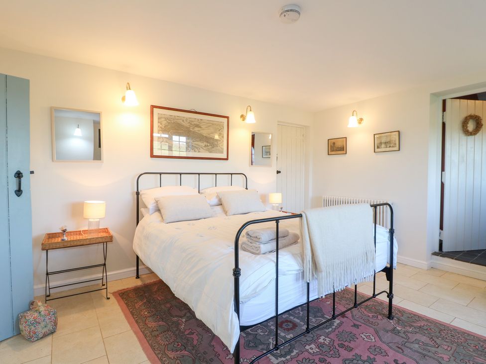 A bedroom with a bed and bedside table at Gapstile in Abbots Bromley