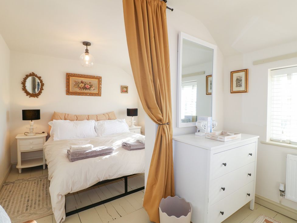 A bedroom with a bed and nightstands at Gapstile in Abbots Bromley