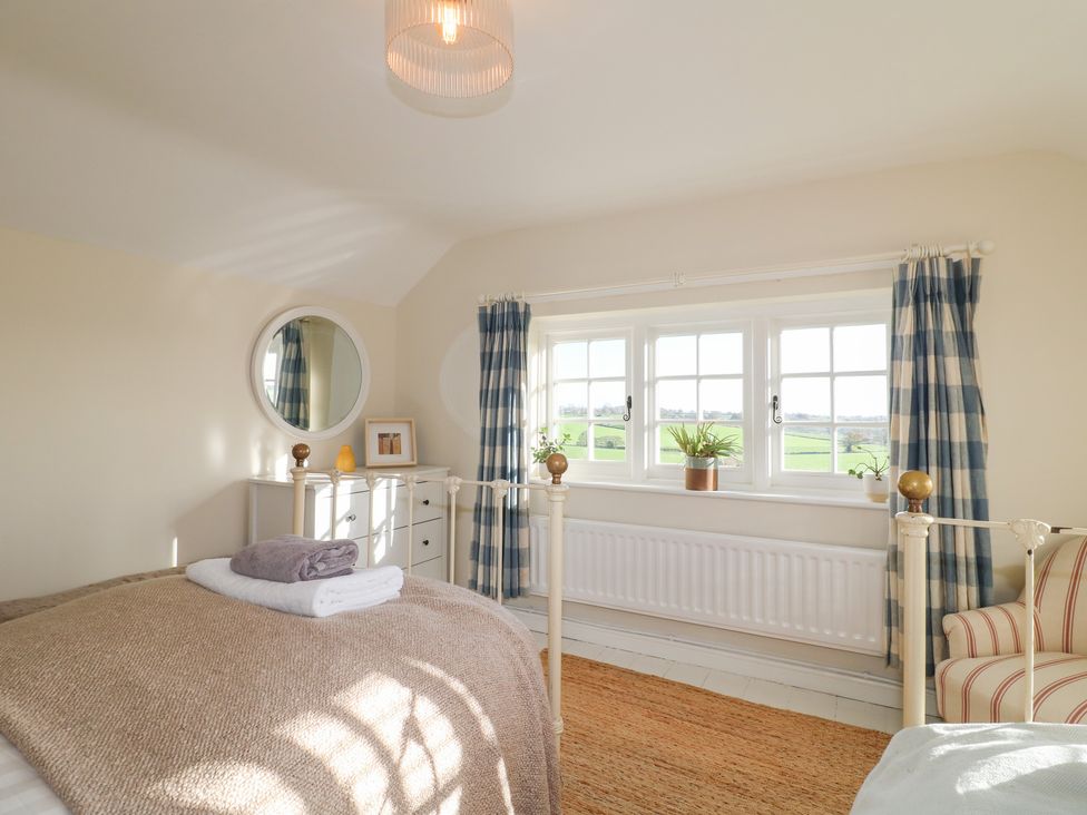 A bedroom with a bed and dresser at Gapstile in Abbots Bromley