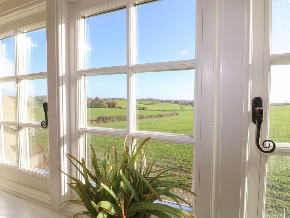 A window with a view of fields and a plant at Gapstile in Abbots Bromley