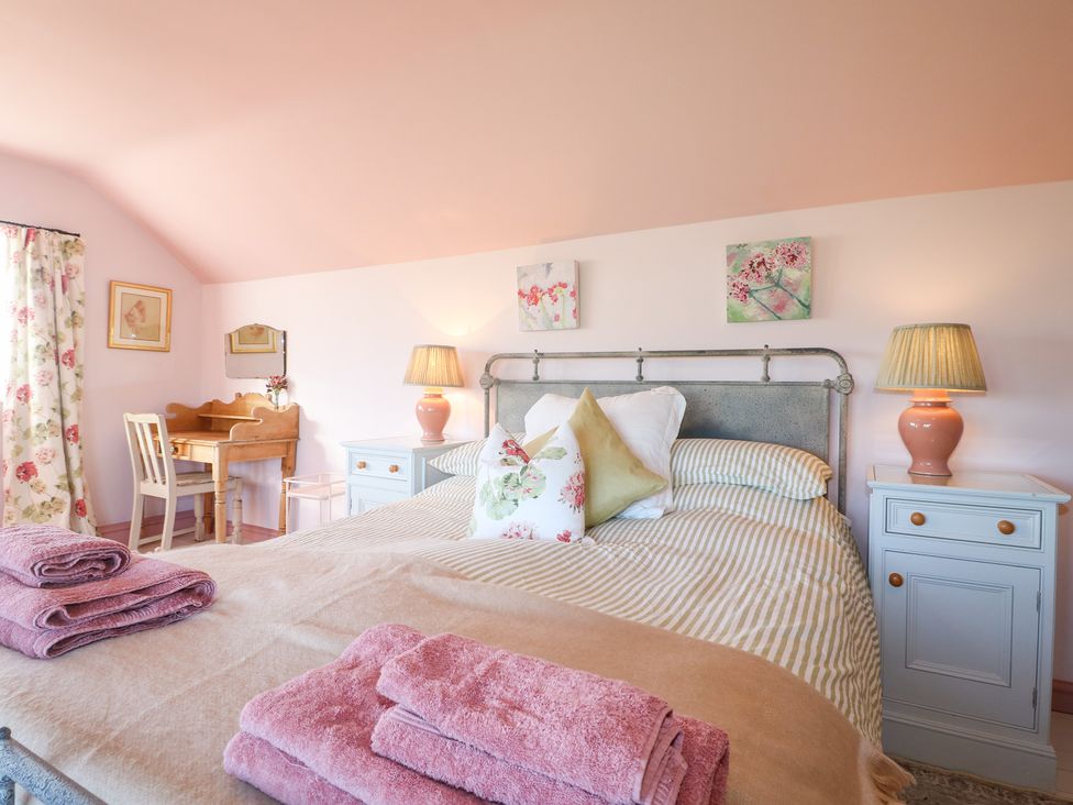 A bedroom with a bed and a desk at Gapstile in Abbots Bromley