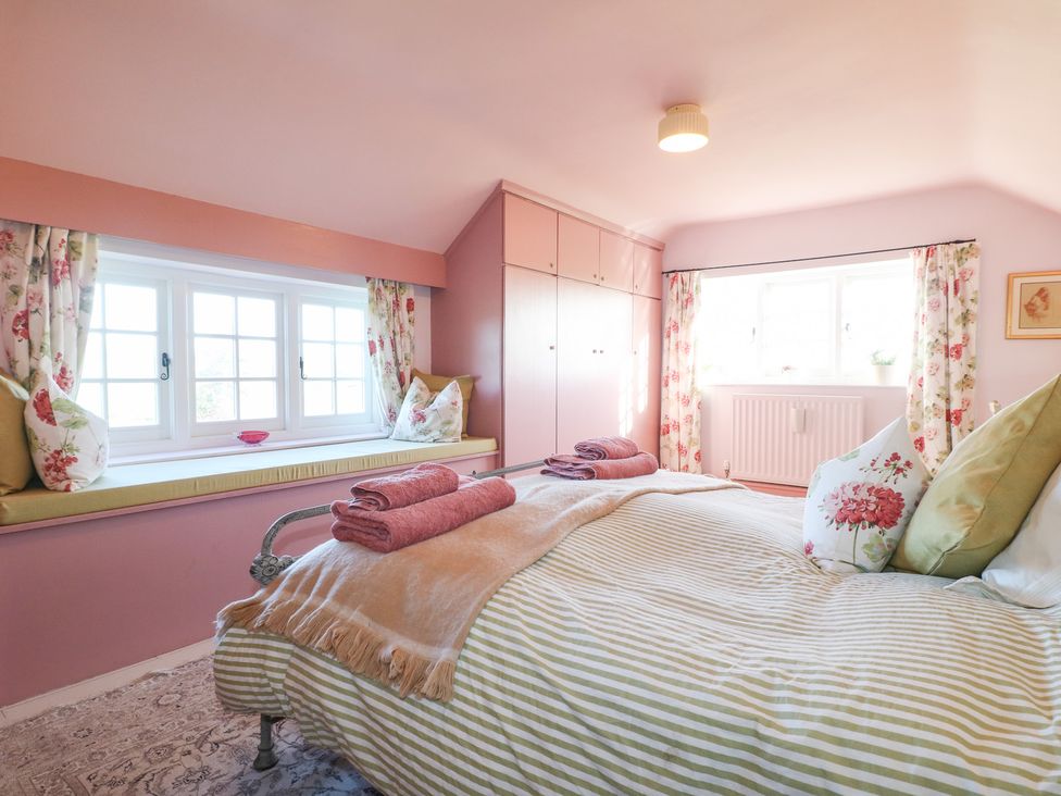 A bedroom with a bed and window at Gapstile in Abbots Bromley