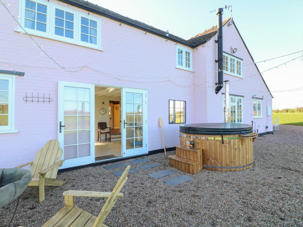 An outdoor area with a hot tub steps and gravel at Gapstile in Abbots Bromley