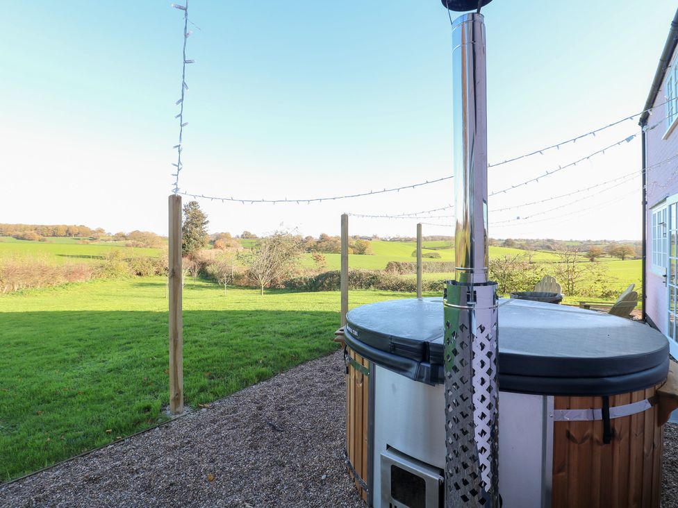 An outdoor area with a hot tub and a view of the landscape at Gapstile in Abbots Bromley