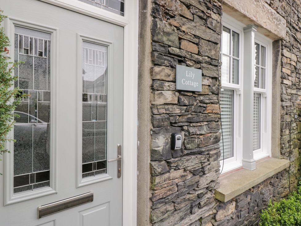 The entrance of a house with a door and window at Lily Cottage in Windermere