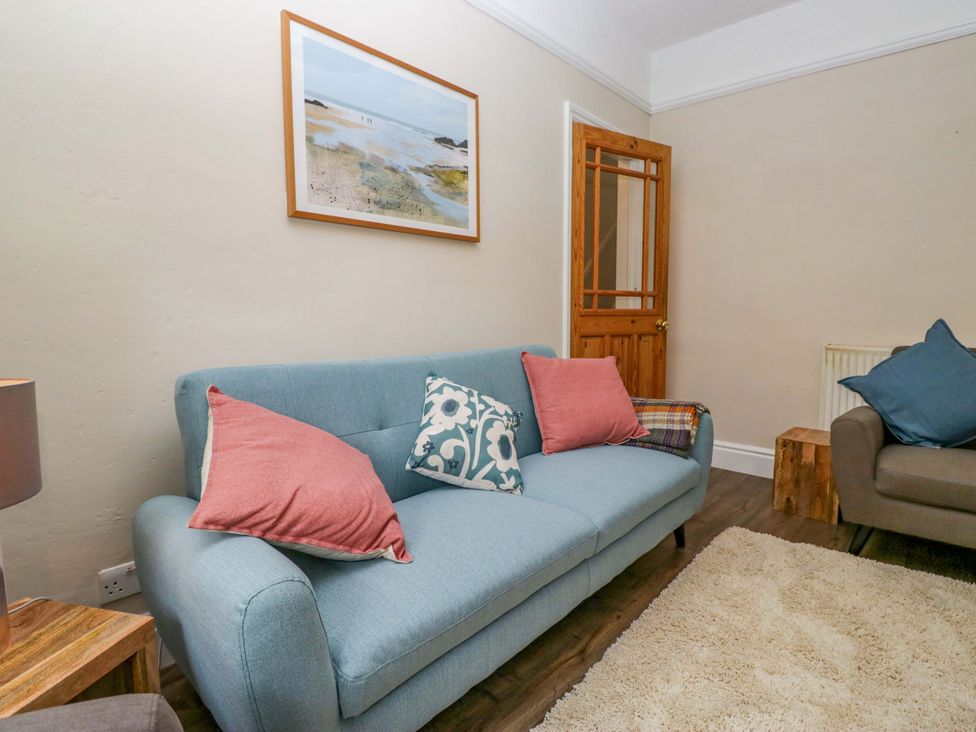 A living room with a sofa and a picture on the wall at 28 Rock Villas in Carnforth