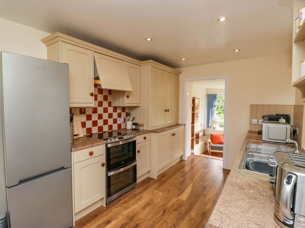 A kitchen with cabinets and appliances at 28 Rock Villas in Carnforth