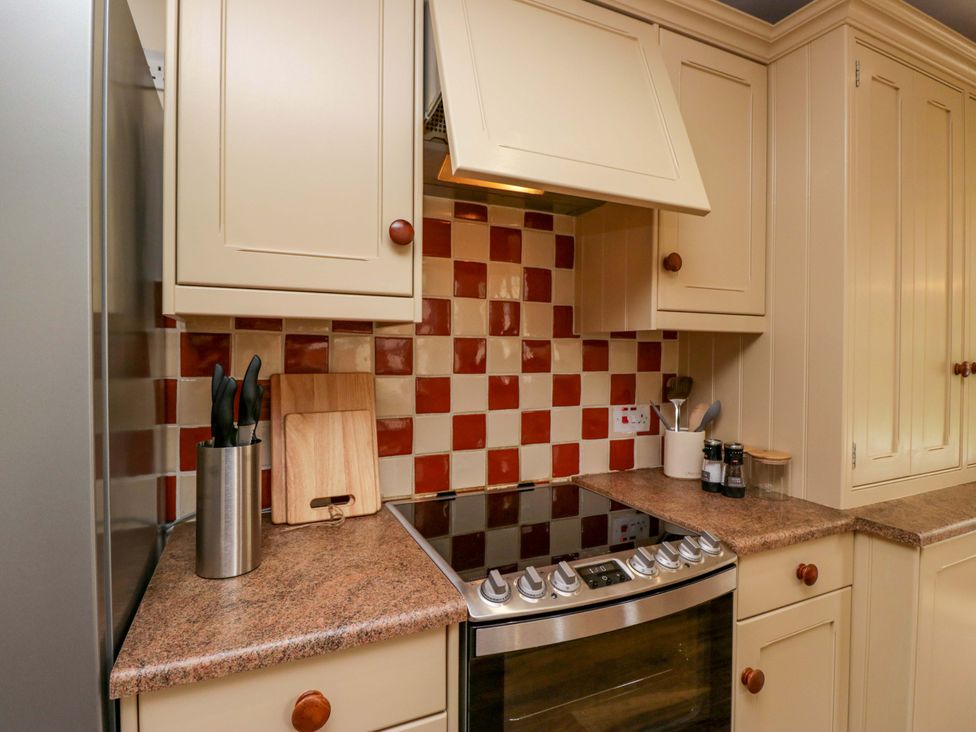 A kitchen with cabinets and a stove at 28 Rock Villas in Carnforth