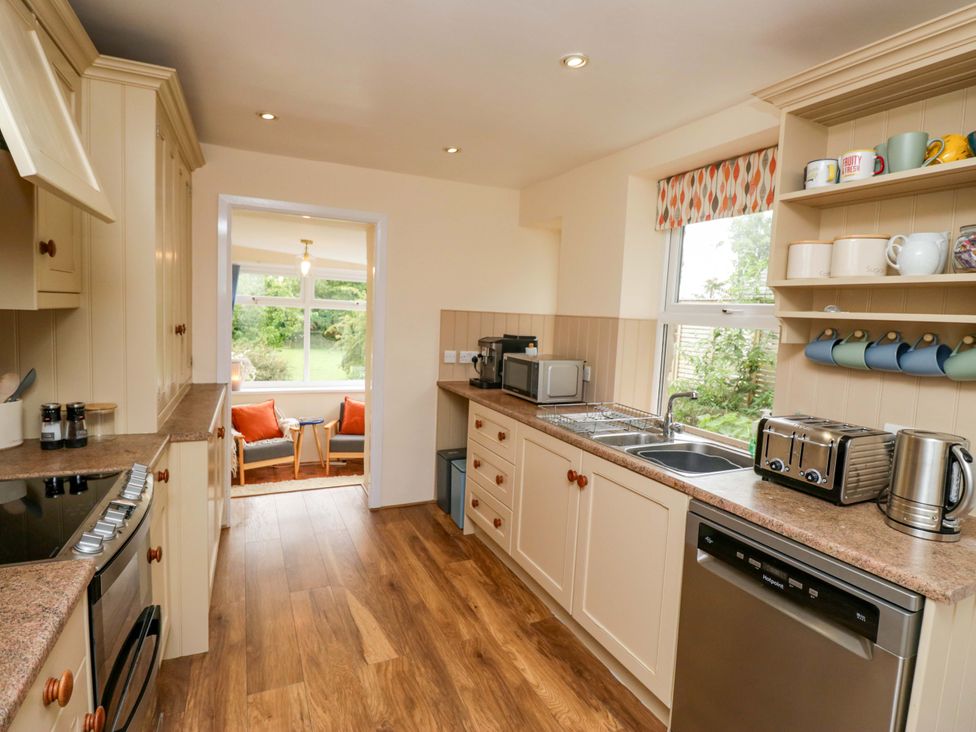 A kitchen with appliances and a view at 28 Rock Villas in Carnforth
