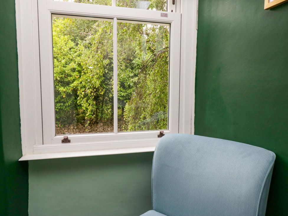 A snug with a chair and a window showing greenery at 28 Rock Villas in Carnforth