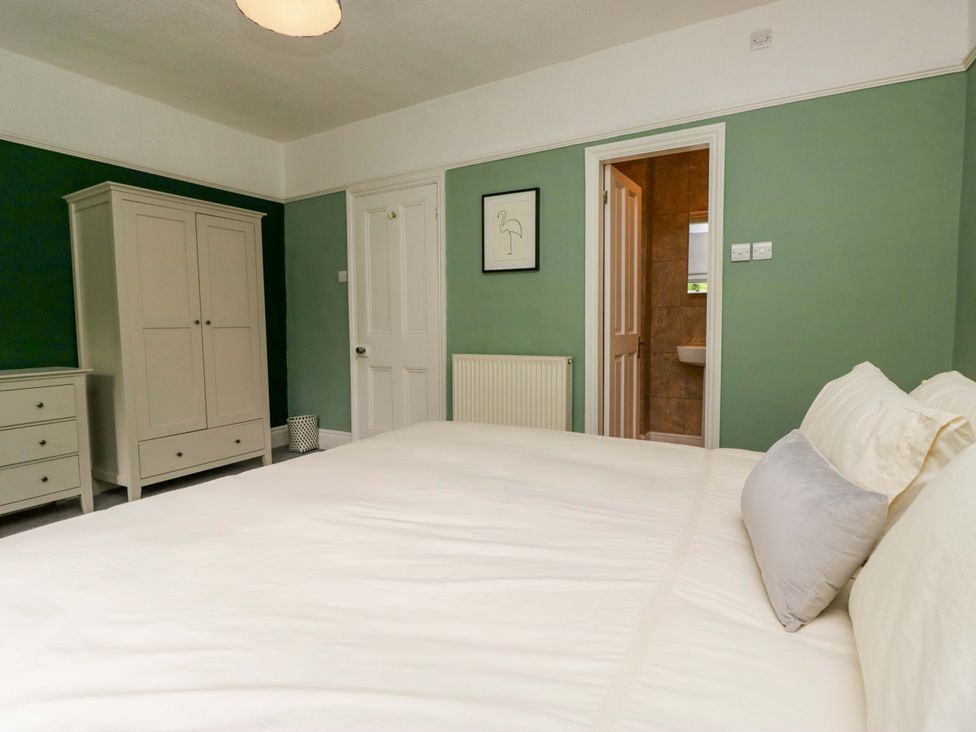 A bedroom with a bed and wardrobe at 28 Rock Villas, Carnforth