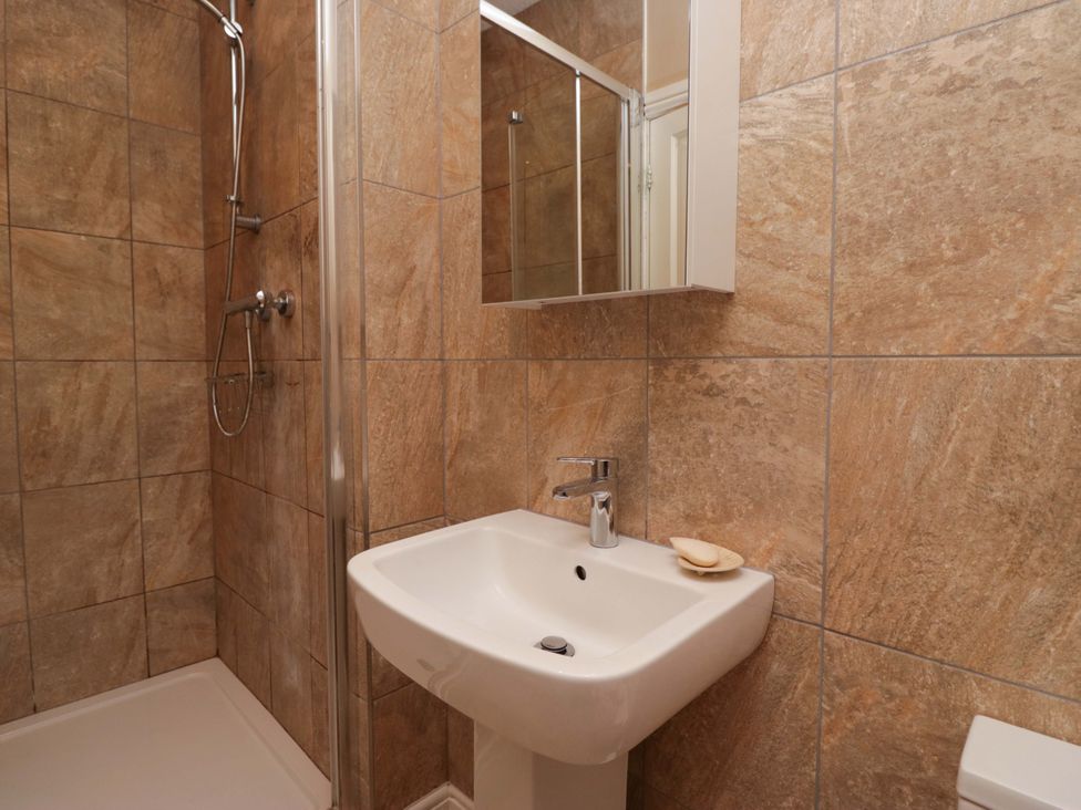 A bathroom with a shower and sink at 28 Rock Villas in Carnforth