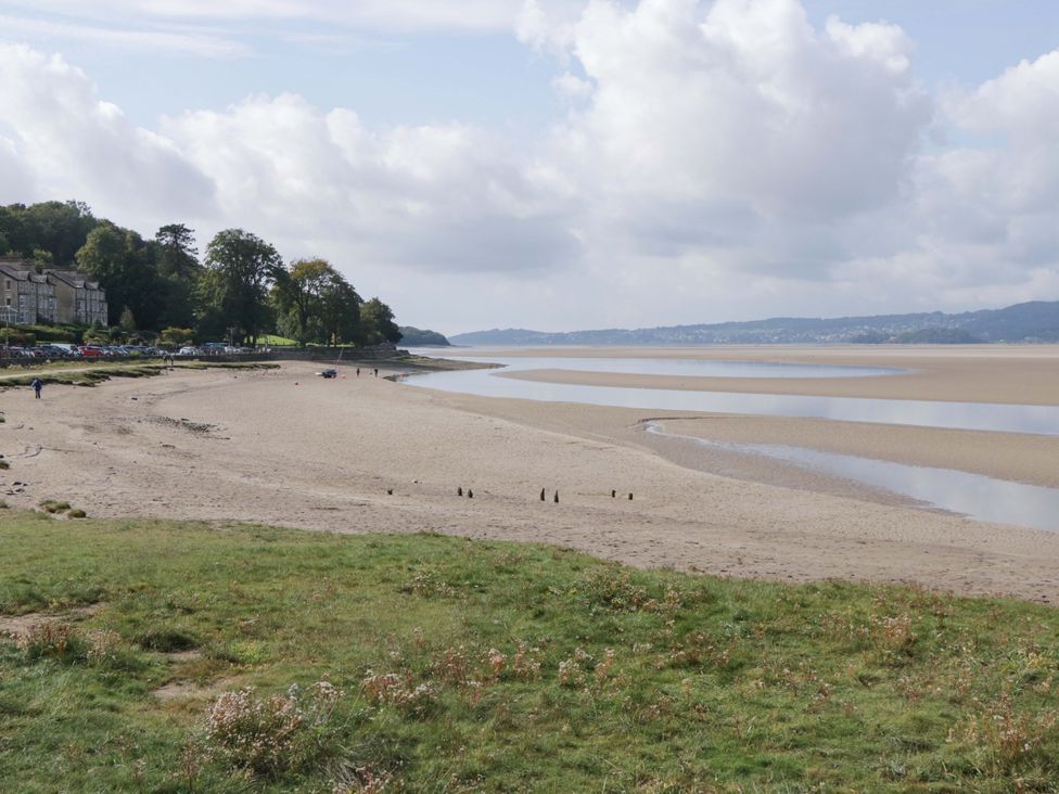 A beach with water and grass at 28 Rock Villas Carnforth