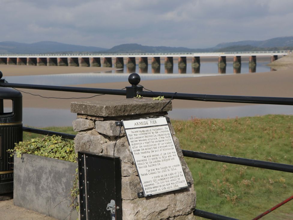 A pier with an information plaque and water view at 28 Rock Villas in Carnforth