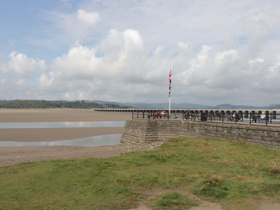 A pier with people sitting along it at 28 Rock Villas Carnforth