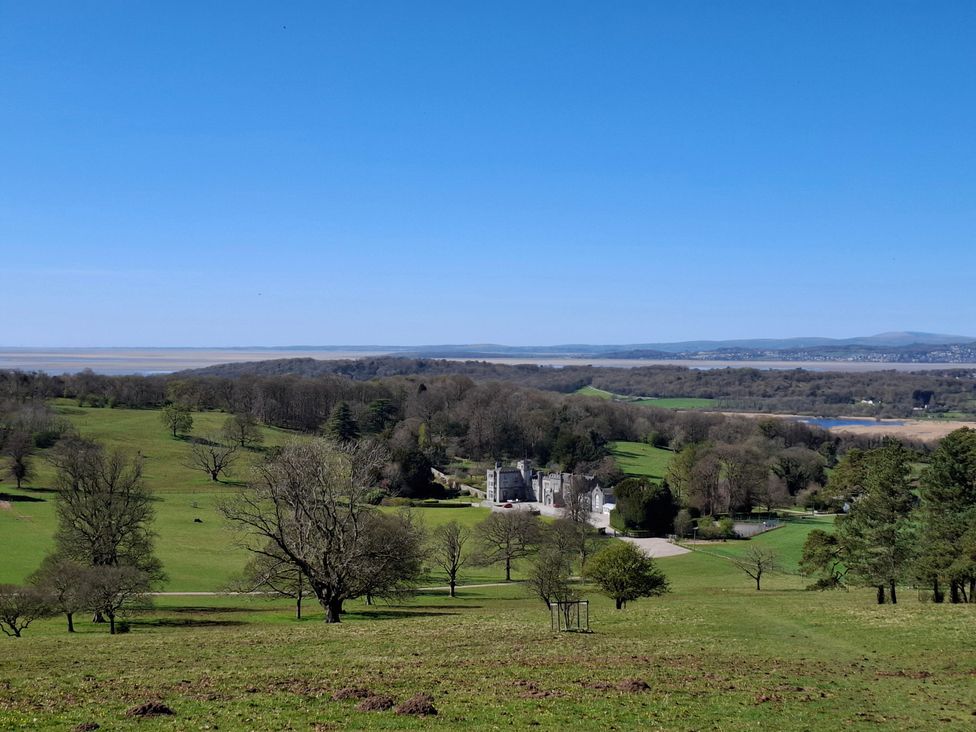 A scenic outdoor view of a building surrounded by trees and a river at 28 Rock Villas Silverdale