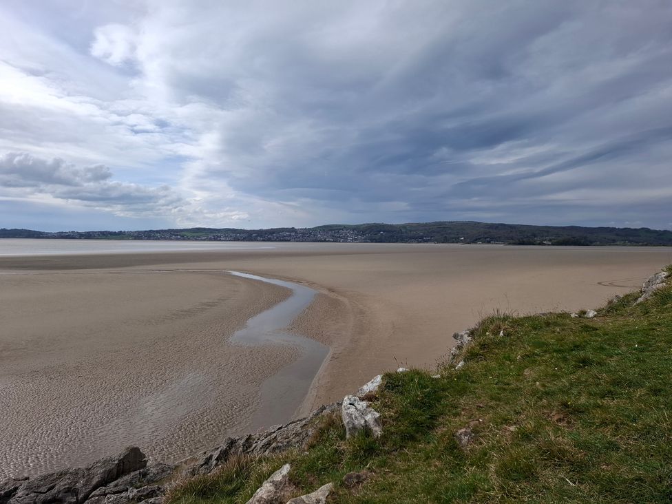 A landscape view of a beach with sand and water at 28 Rock Villas Silverdale