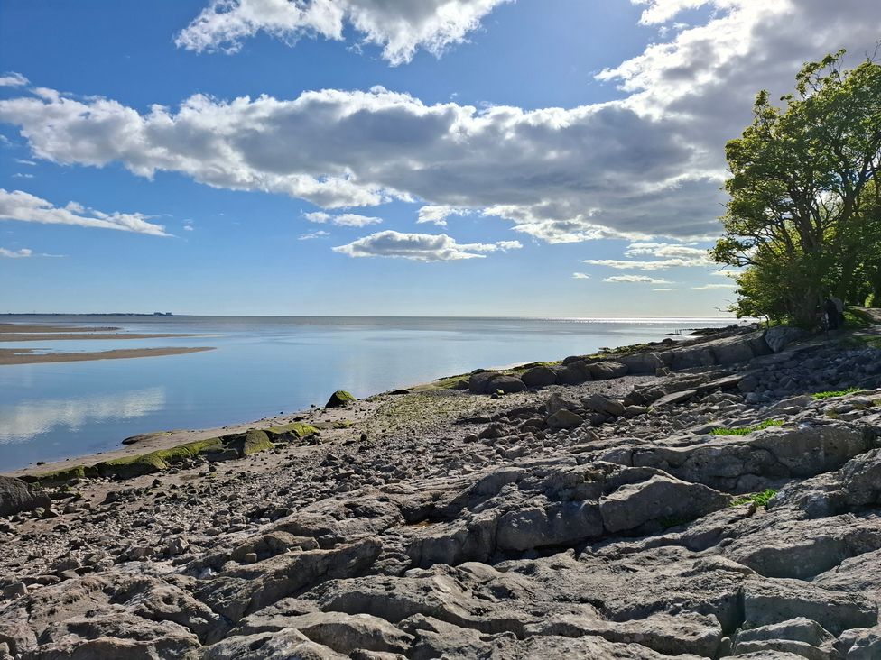 A scenic view of rocks and water under a cloudy sky at 28 Rock Villas Silverdale