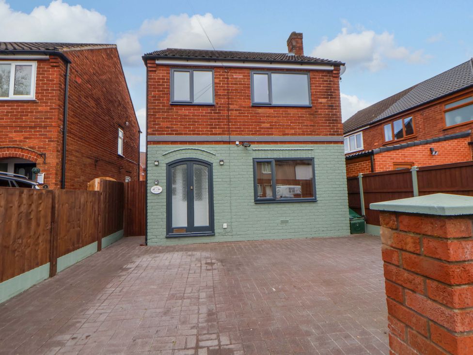 A brick house with driveway and fence at The Cloud House @ Hoole in Chester
