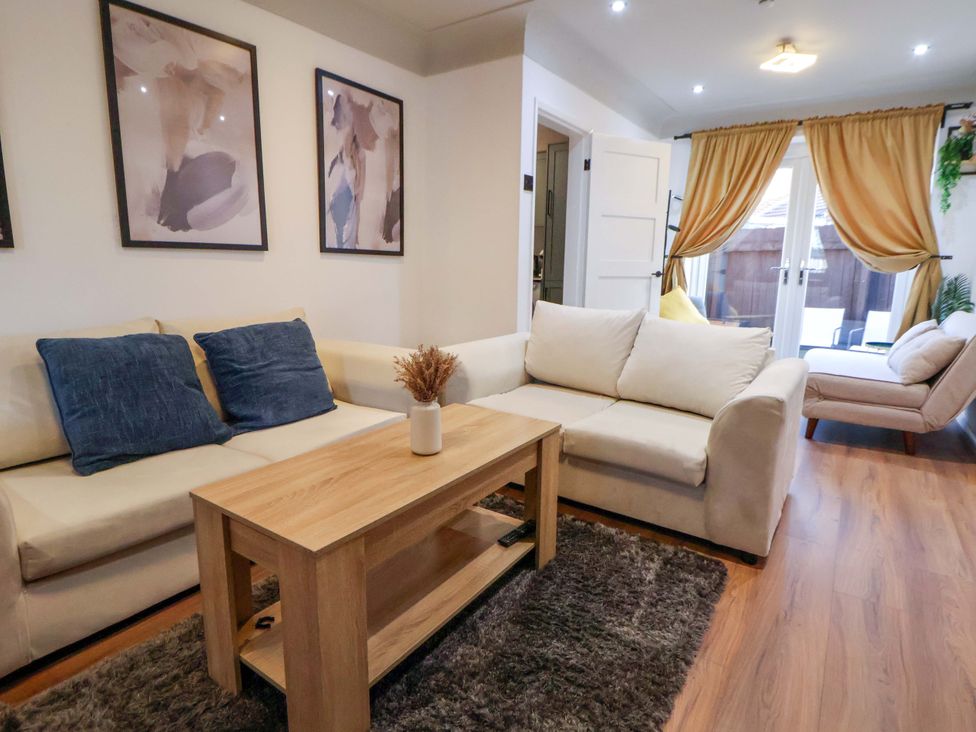 A living room with sofa, table, and artwork at The Cloud House @ Hoole in Chester