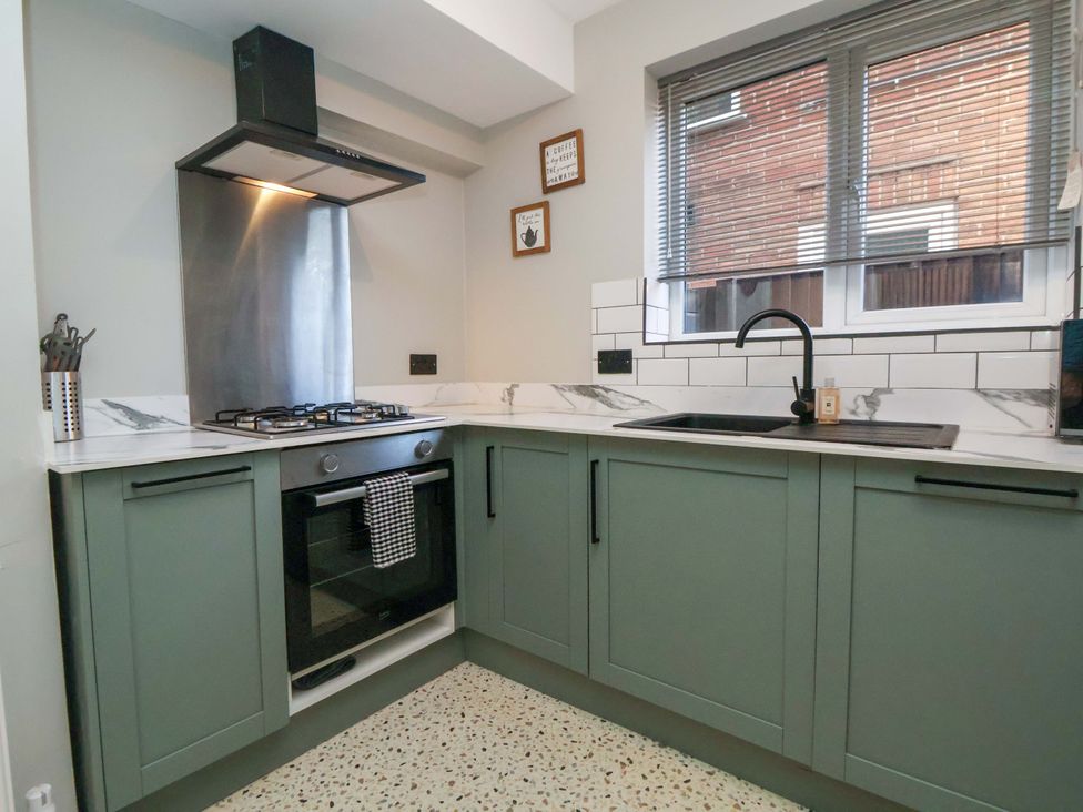 A kitchen with stove, oven, sink, and cabinets at The Cloud House @ Hoole in Chester