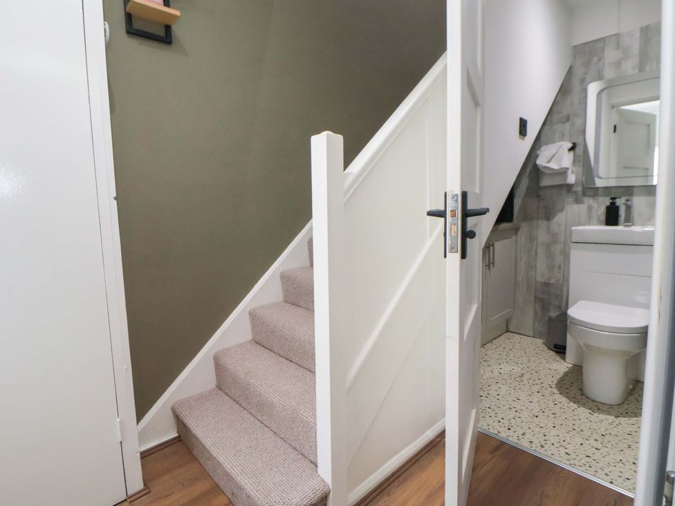 A bathroom with a sink and toilet visible from an entrance at The Cloud House @ Hoole in Chester