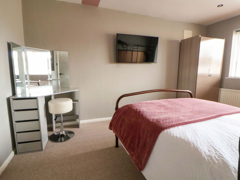 A bedroom with a bed and dresser at The Cloud House @ Hoole in Chester