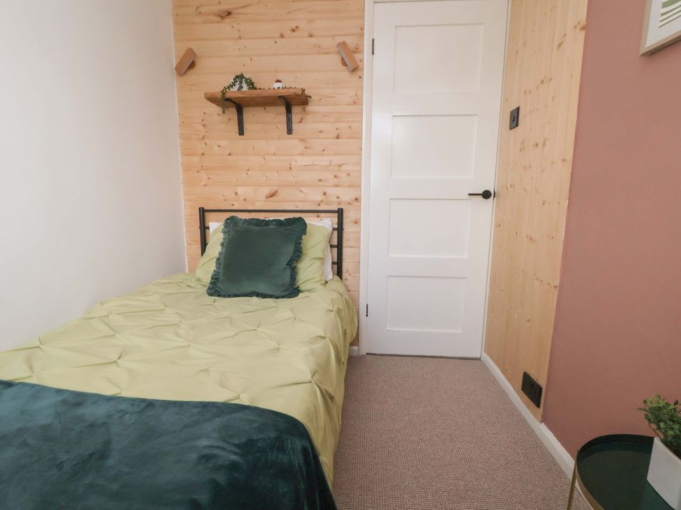 A bedroom with a bed and shelf at The Cloud House @ Hoole in Chester
