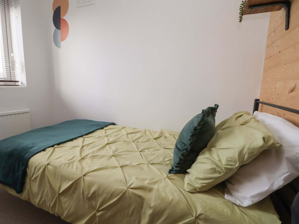 A bed with pillows and a blanket in a bedroom at The Cloud House @ Hoole in Chester