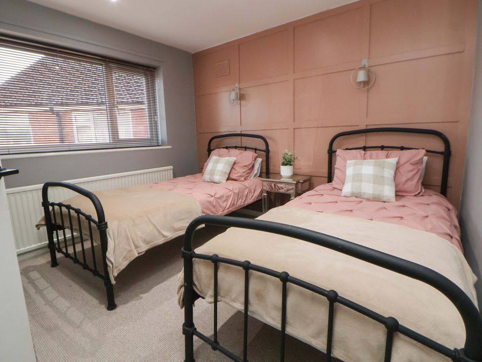 A bedroom with two beds and a bedside table at The Cloud House @ Hoole in Chester