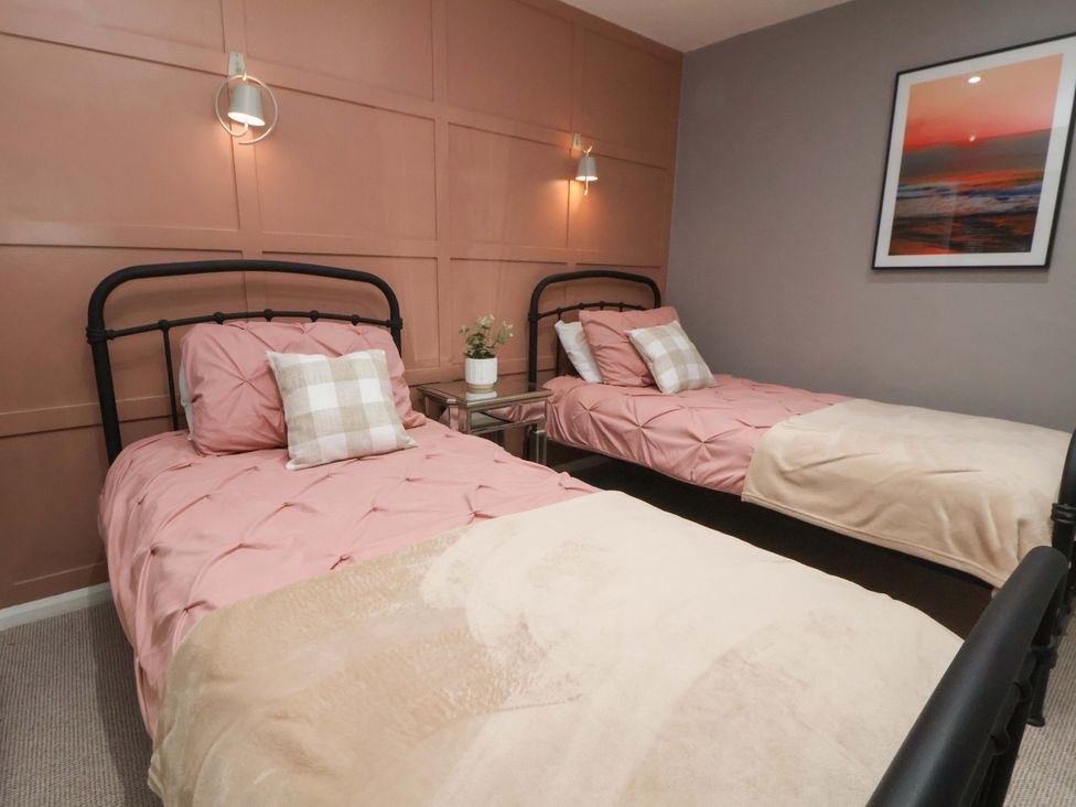 A bedroom with two beds and a nightstand at The Cloud House @ Hoole in Chester