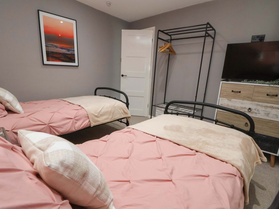 A bedroom with two beds and a wardrobe at The Cloud House @ Hoole in Chester