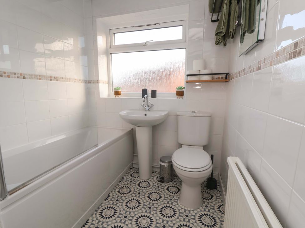 A bathroom with a bathtub, sink and toilet at The Cloud House @ Hoole in Chester