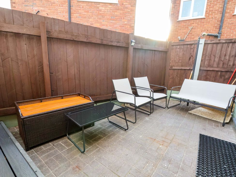 An outdoor patio with seating and a table at The Cloud House @ Hoole in Chester