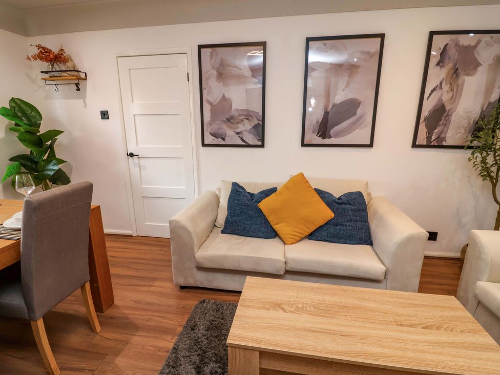 A living room with a sofa and dining area at Steam and Stay @ Hoole in Chester