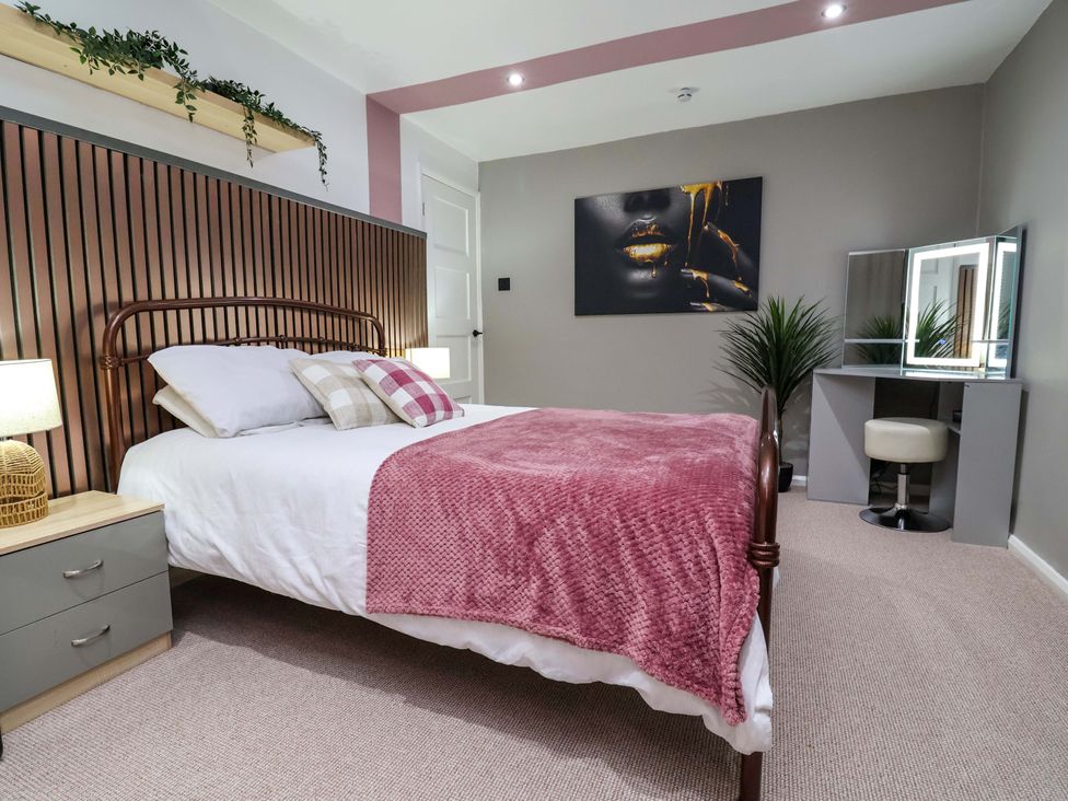 A bedroom with a bed and a mirror at Steam and Stay @ Hoole in Chester