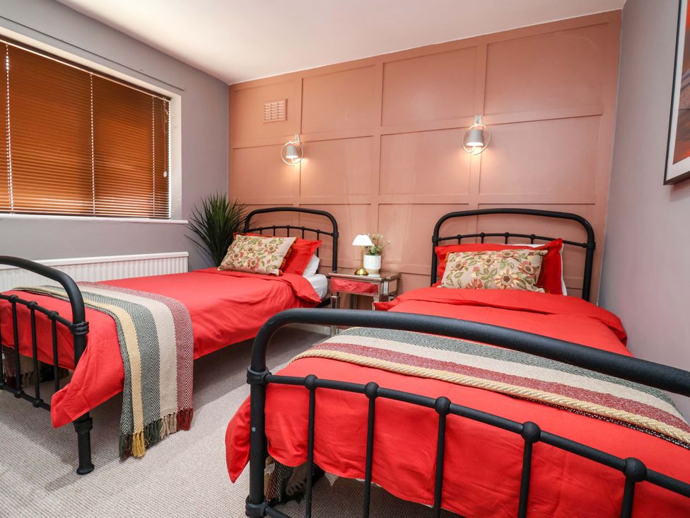 A bedroom with two metal beds and a bedside table at Steam and Stay @ Hoole in Chester