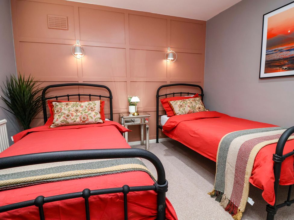 A bedroom with two beds and a nightstand at Steam and Stay @ Hoole in Chester