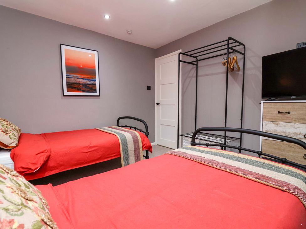 A bedroom with two beds and a wardrobe at Steam and Stay @ Hoole in Chester