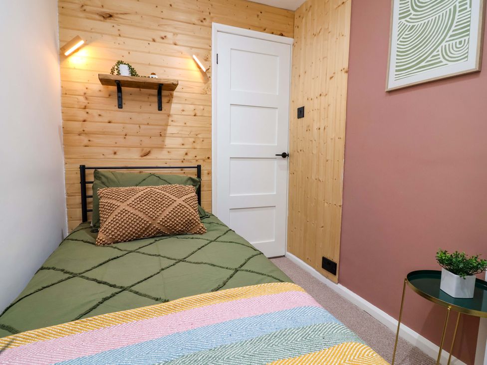 A bedroom with a bed and shelf at Steam and Stay @ Hoole in Chester