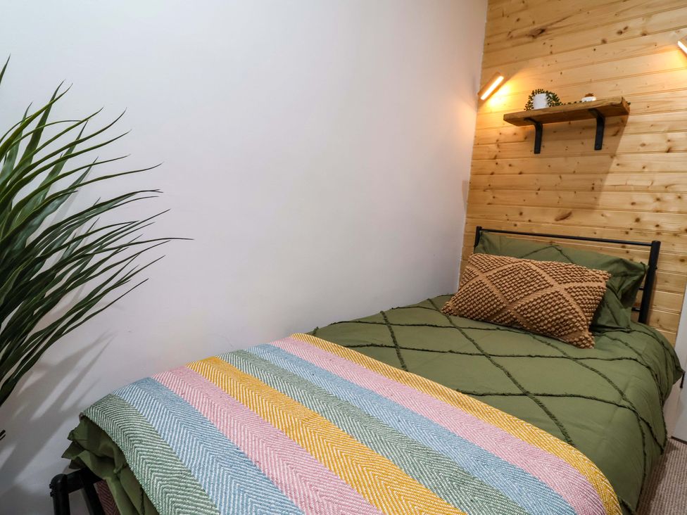 A bedroom with a bed and a plant at Steam and Stay @ Hoole in Chester