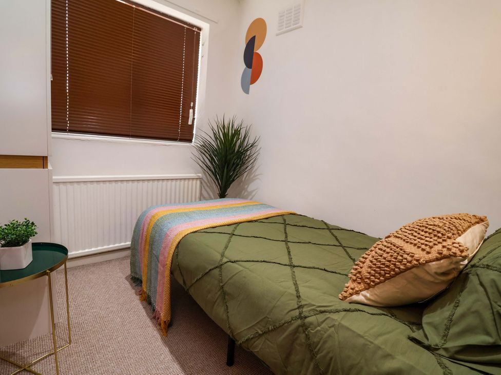 A bedroom with a bed and a plant at Steam and Stay @ Hoole in Chester