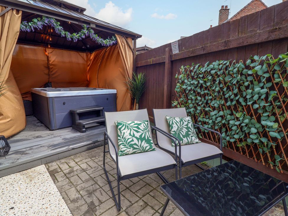 A garden with a hot tub and seating area at Steam and Stay @ Hoole in Chester