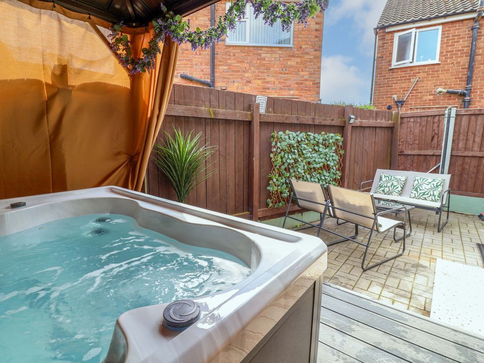 A garden with a hot tub and seating area at Steam and Stay @ Hoole in Chester