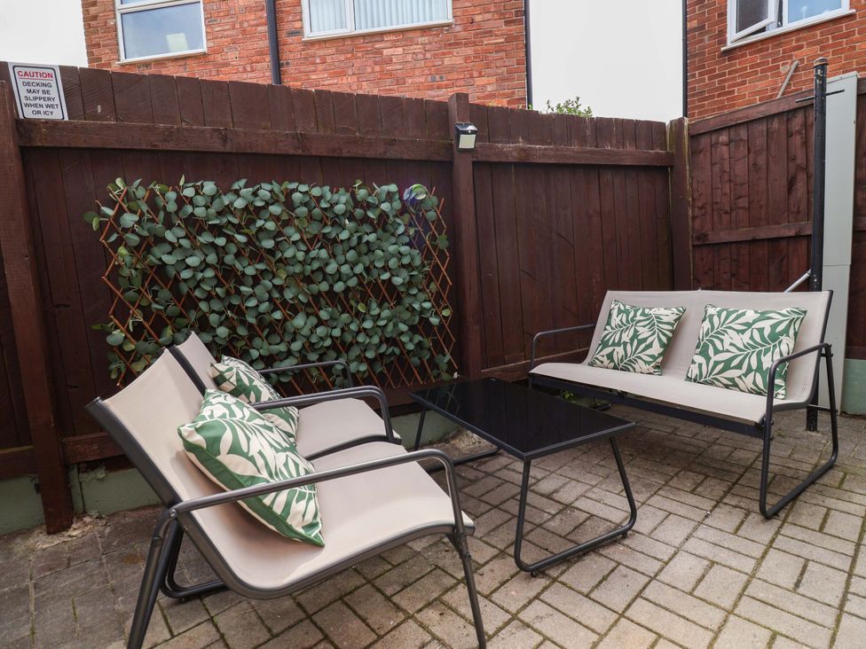 An outdoor seating area with a sofa and coffee table at Steam and Stay @ Hoole in Chester