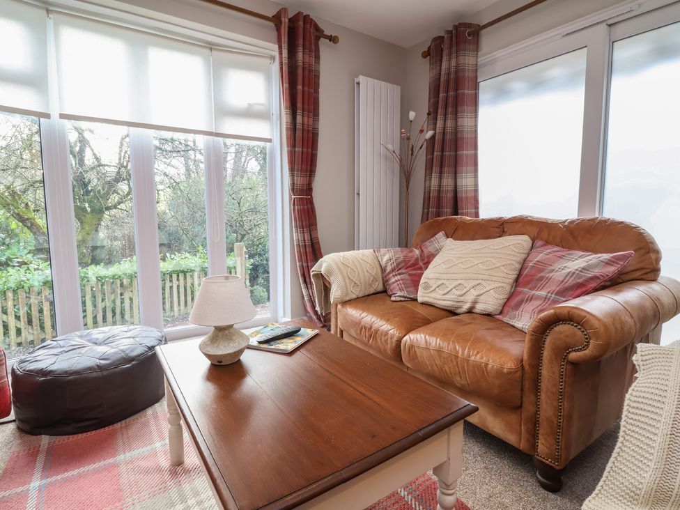 A living room with a leather sofa and coffee table at Little Willesleigh Goodleigh near Barnstaple