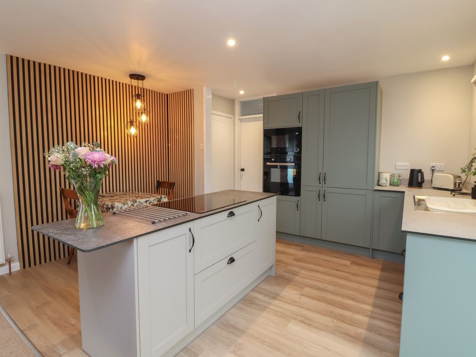 A kitchen with a kitchen island and oven at Little Willesleigh Goodleigh near Barnstaple